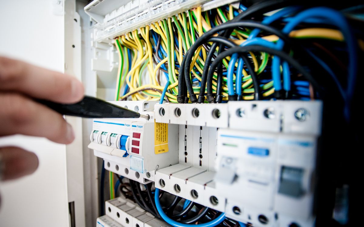 Electrician working in a service panel