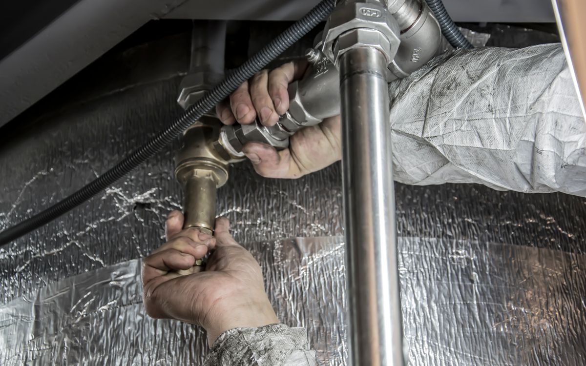 Plumber fitting a water heater